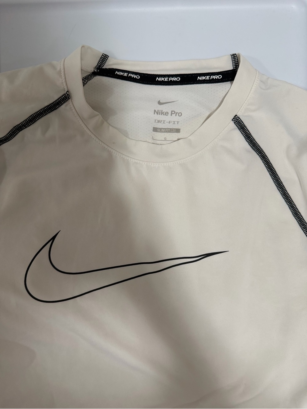 Nike Men’s Dri-FIT Short Sleeve Shirt in Off-White with Black Swoosh